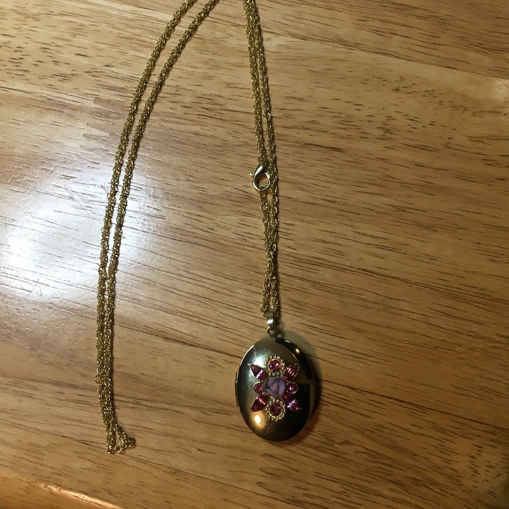 Beautiful gold colored locket with floral design
